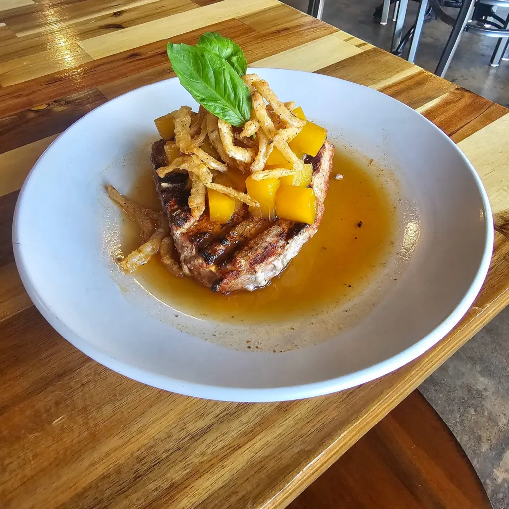 Peach pork porter dish plated with garnish